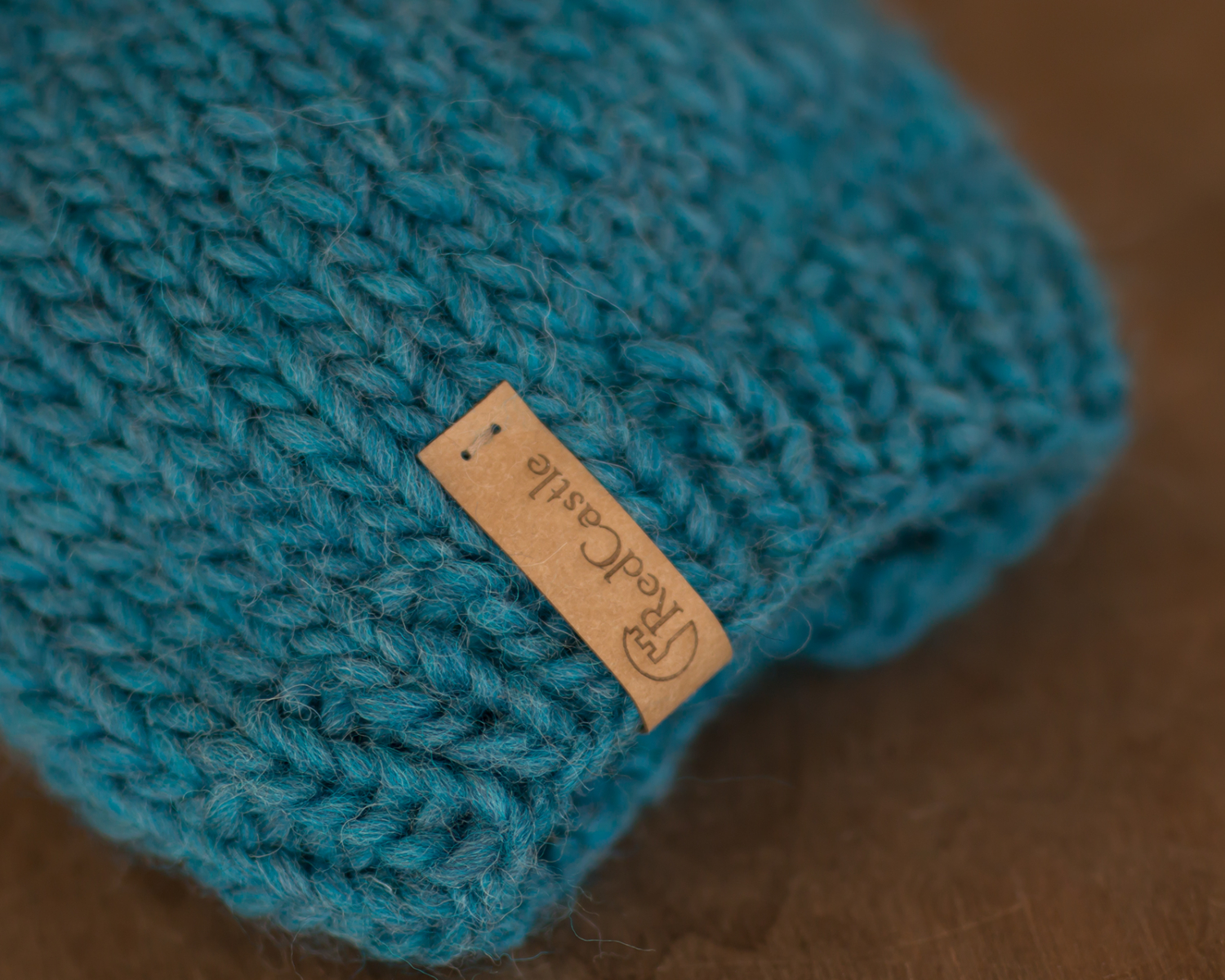 Teal, chunky knit pom-pom hat for girls or boys